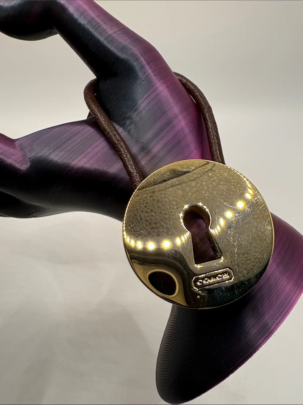 Coach Gold-Tone Padlock Charm on Brown Leather Loop